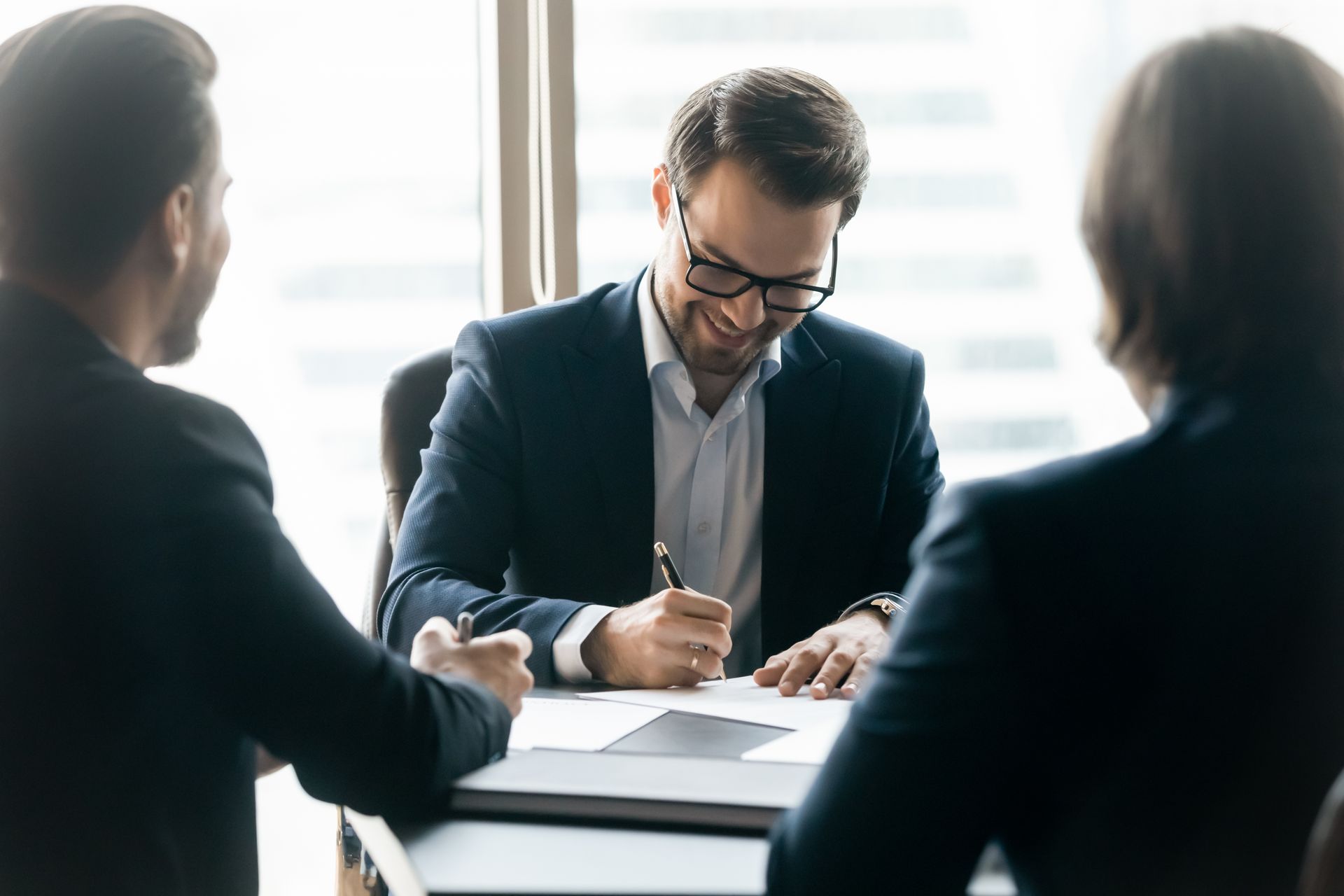 man signing documents