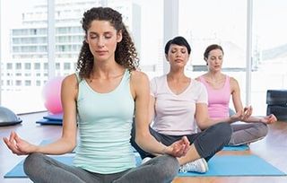 Group of women meditating — Regeneration Station in Lenexa, KS