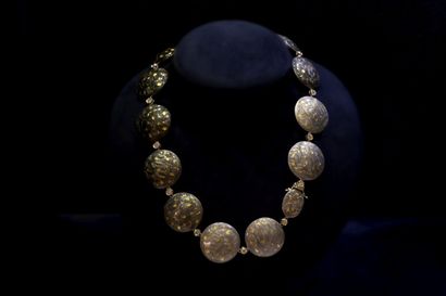 Collana di perline in oro e argento esposta su un busto blu scuro su sfondo nero Bruna Guglielmi Genova