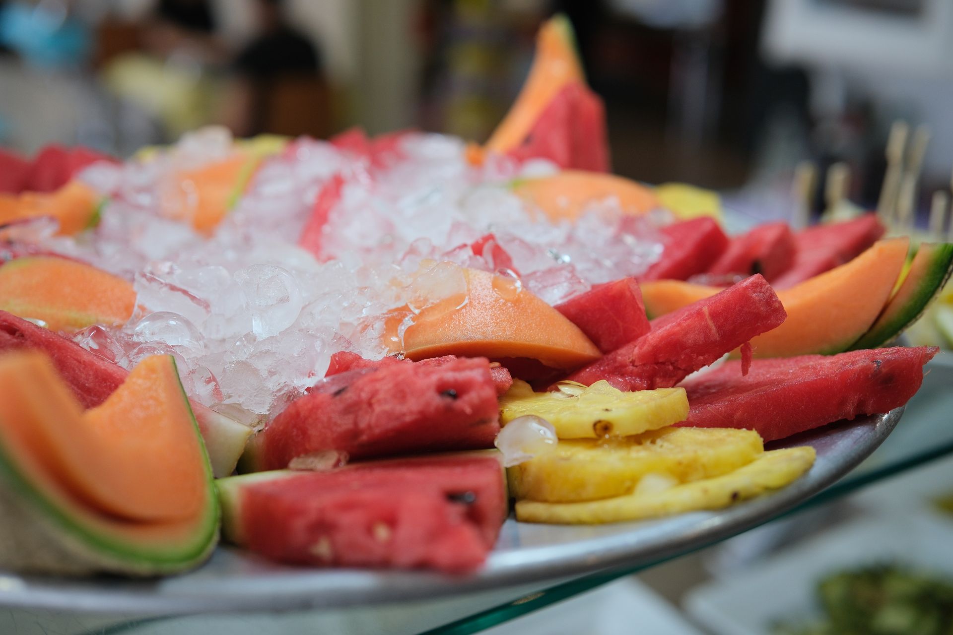 Piatto di frutta con anguria, melone cantalupo, ananas e ghiaccio.