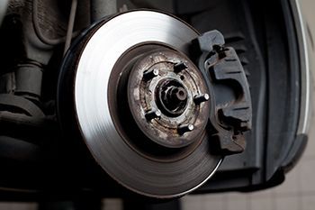 A close up of a brake disc on a car.