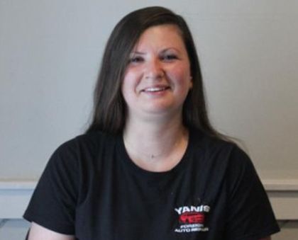 A woman wearing a yankee t-shirt smiles for the camera