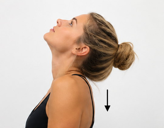Smiling woman with blonde hair in a black tank top against a plain background
