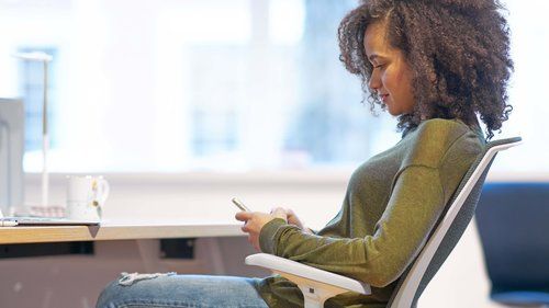 Woman Using her Phone — Riverside, CA — TotalPlan Business Interiors Inc