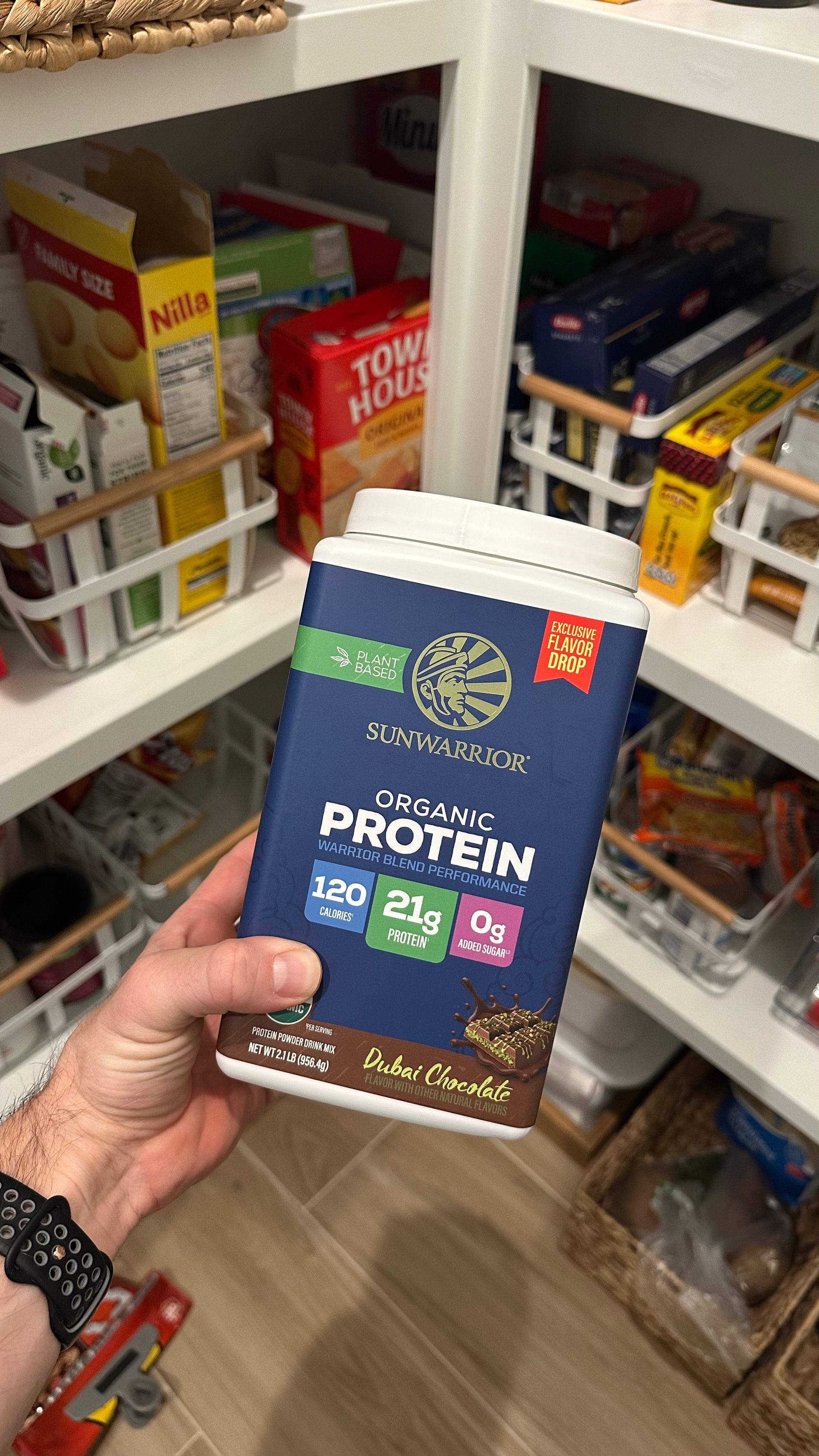 Person holding a tub of 