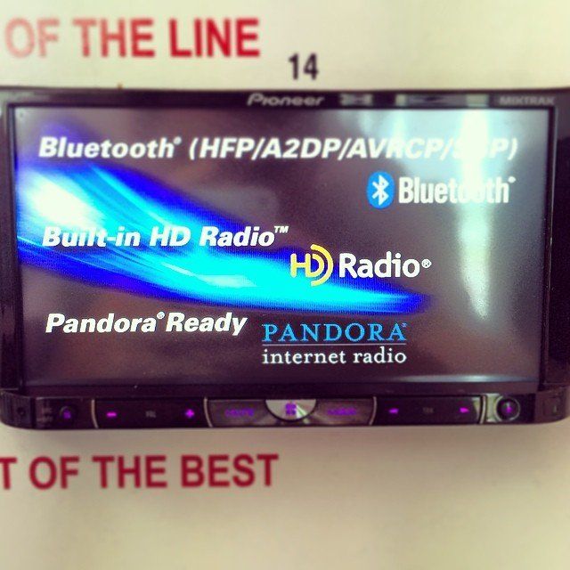 Pioneer car stereo with Bluetooth, HD Radio, and Pandora capabilities displayed on its screen.