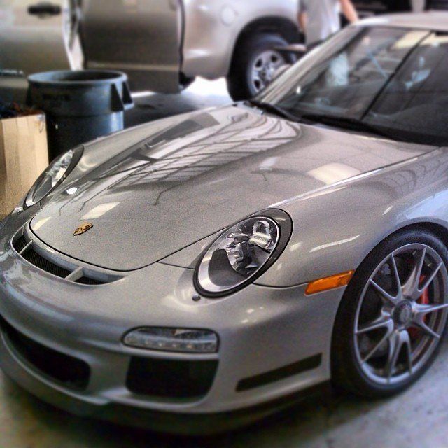 Silver Porsche sports car in a garage.