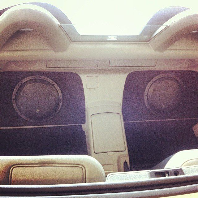 Two car subwoofers in a custom interior panel.