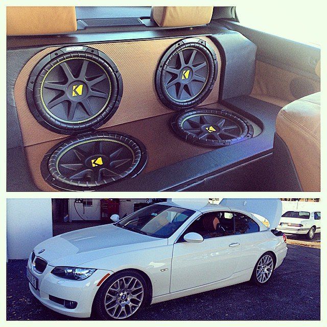 White BMW coupe with custom car audio system featuring four Kicker subwoofers.