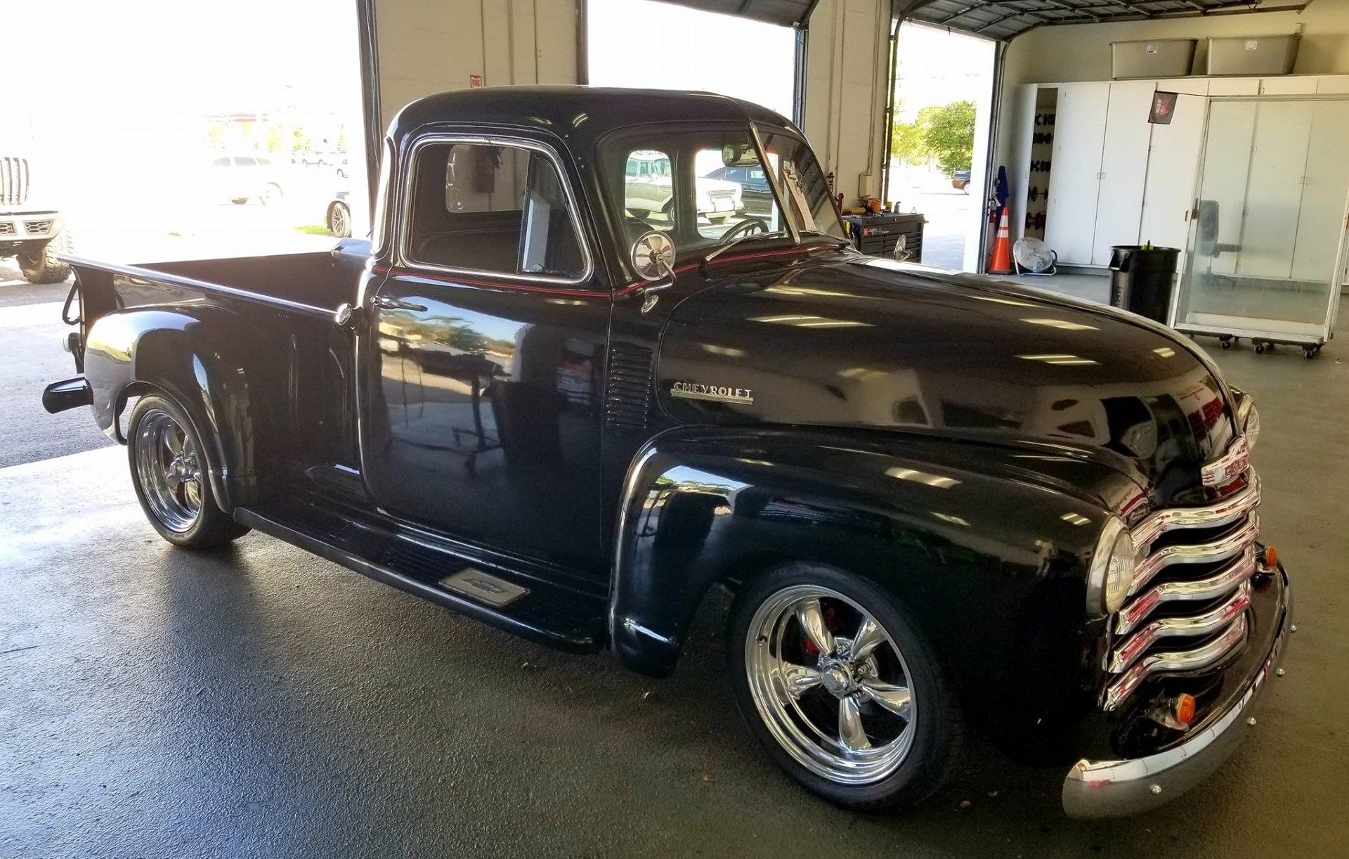 Black vintage Chevrolet pickup truck with chrome accents.