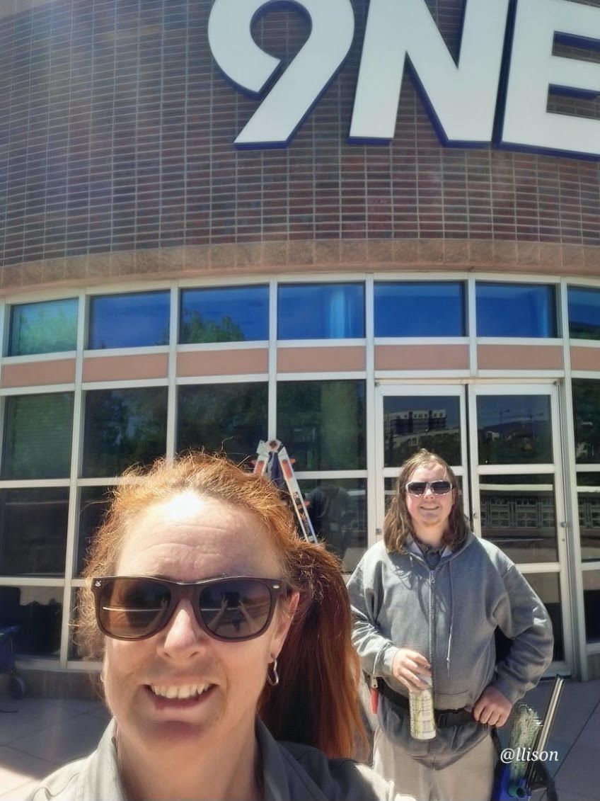 Two women standing in front of a 9ne store