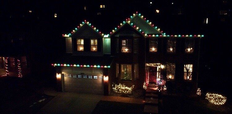 A house is decorated with christmas lights at night