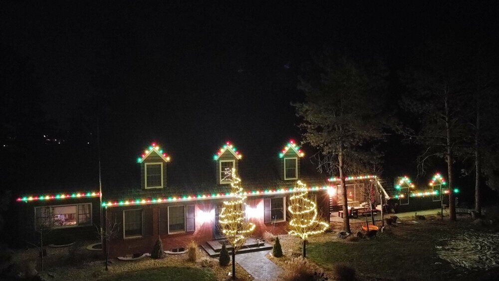 A house is decorated with christmas lights at night.