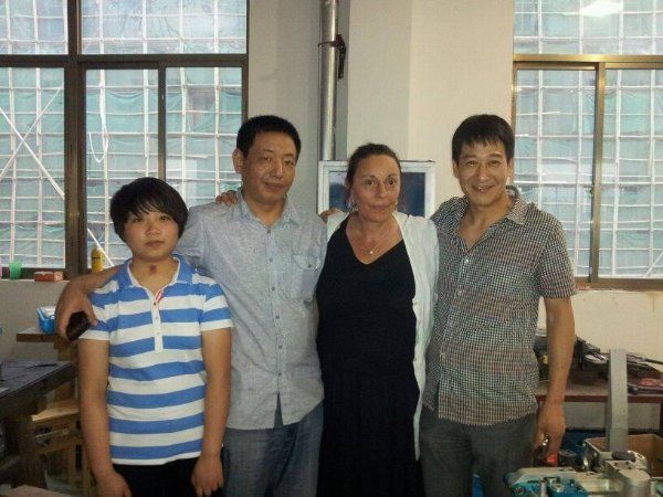 A group of people posing for a picture in front of a window