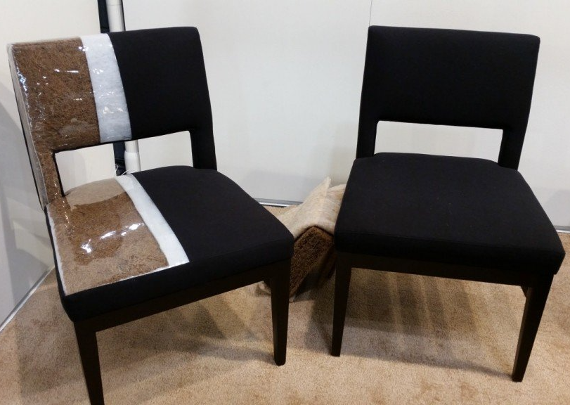 Two black chairs are sitting next to each other on a carpet