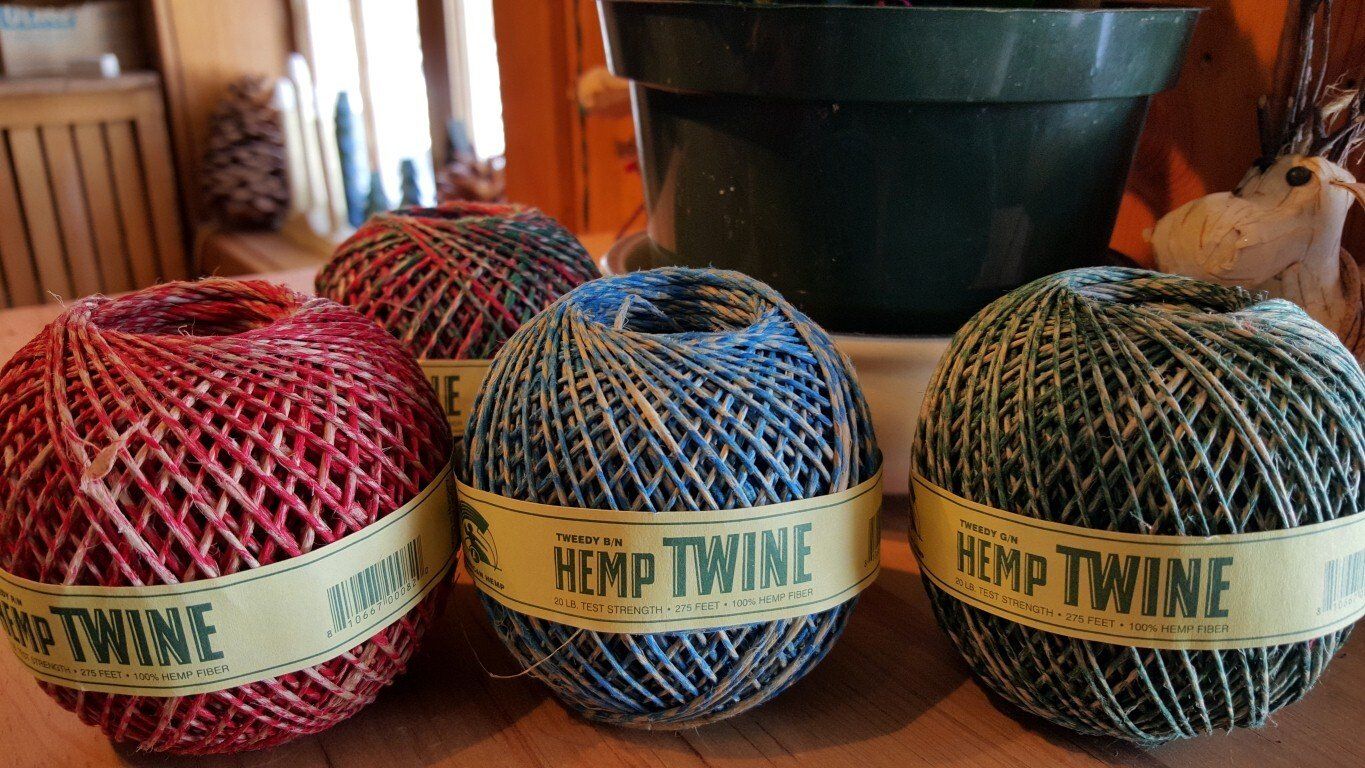 Three balls of hemp twine are sitting on a table