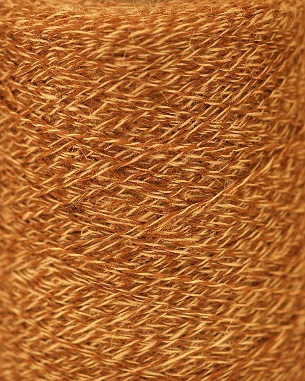 A close up of a spool of brown yarn.