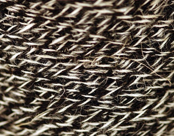 A close up of a knitted fabric with a geometric pattern.