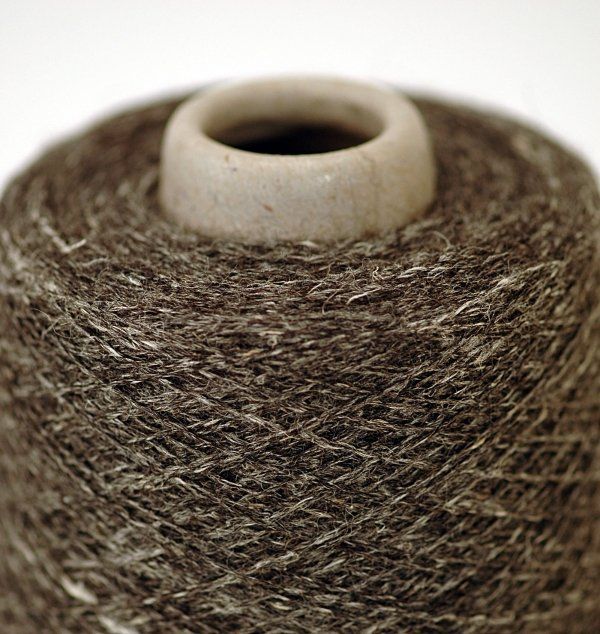 A close up of a spool of brown yarn
