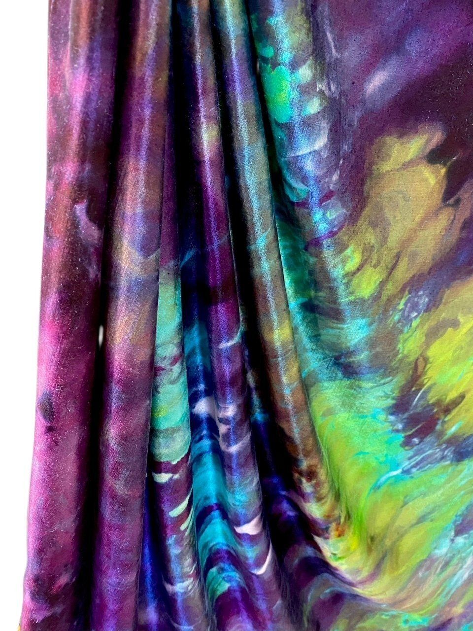 A close up of a purple and green tie dye fabric