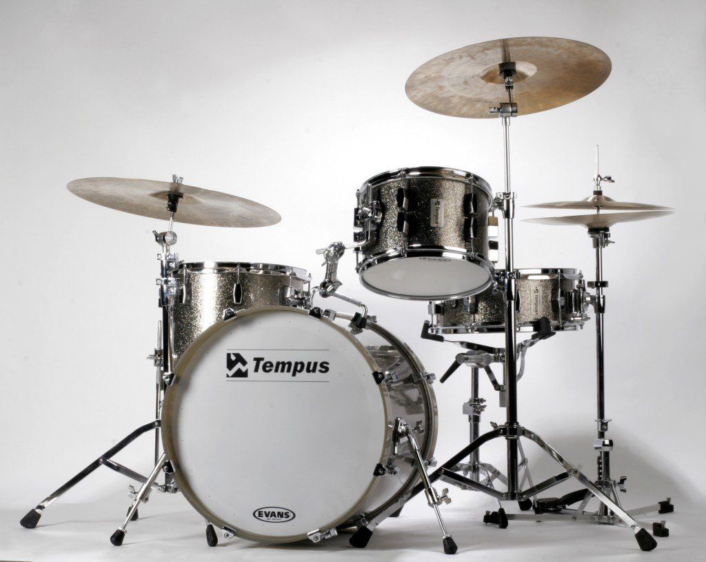 A timpus drum set is sitting on a white surface