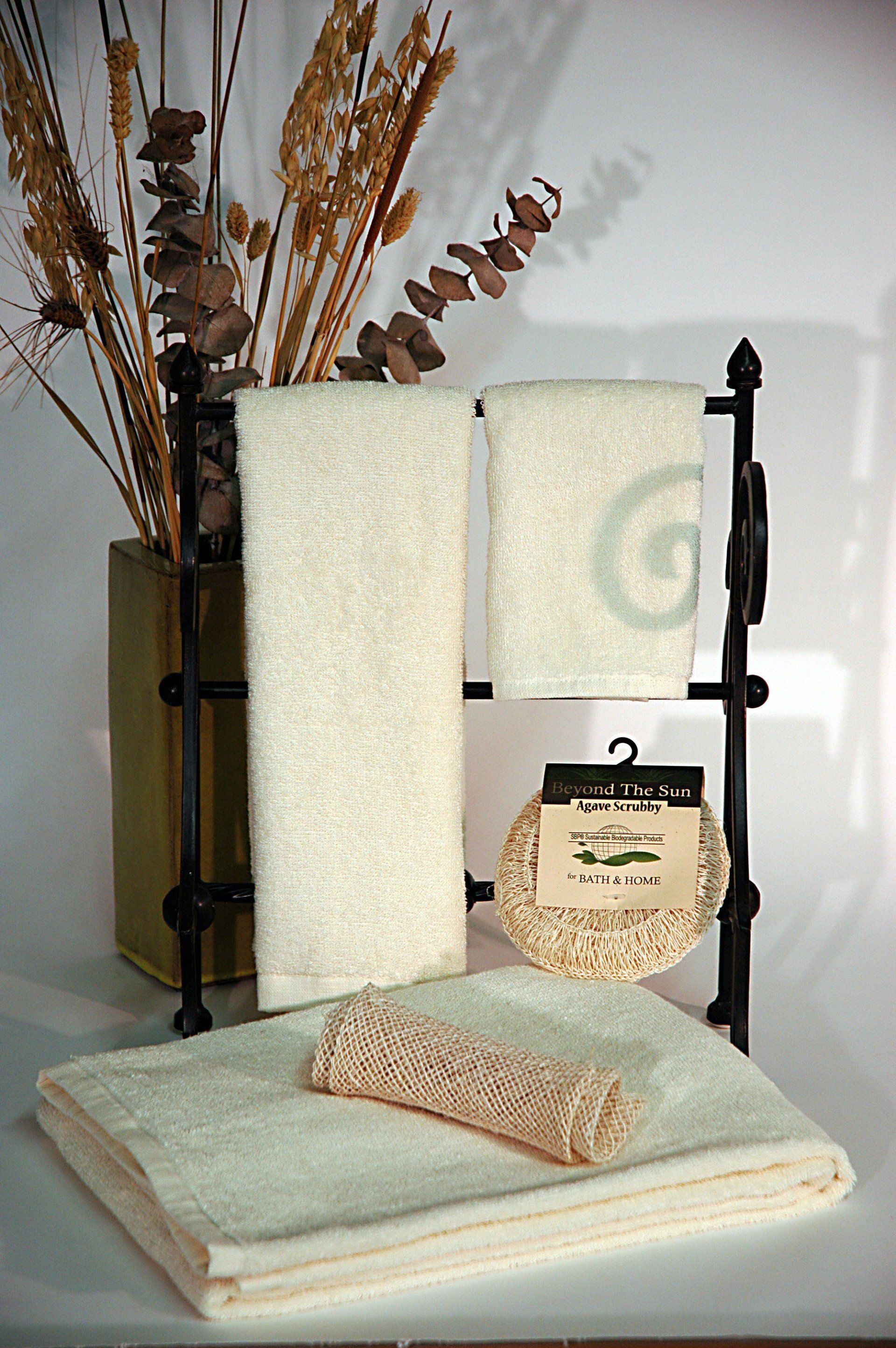 A towel rack with towels and a sponge on it