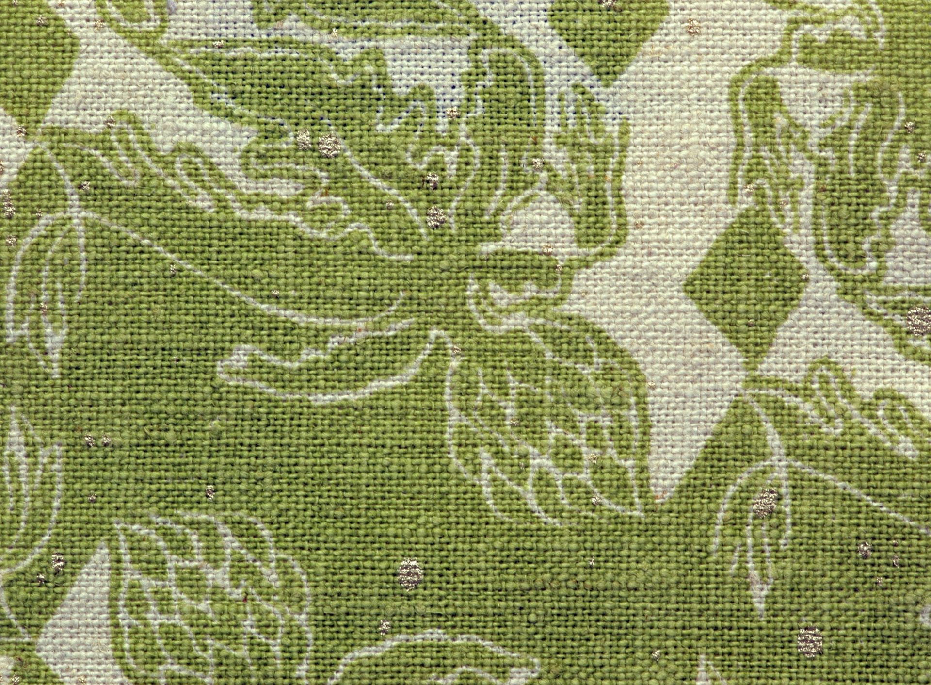 A close up of a green and white fabric with leaves on it.