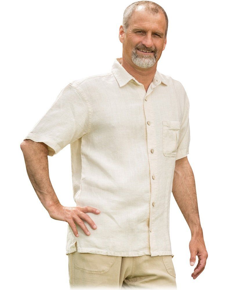 A man with a beard wearing a white shirt and khaki pants