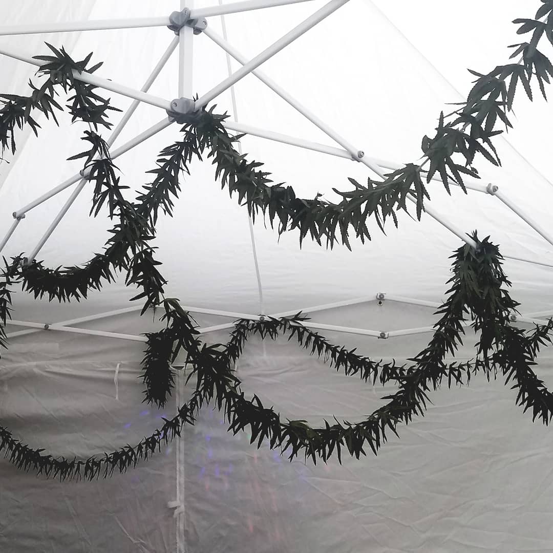 A tent with a lot of garlands hanging from the ceiling