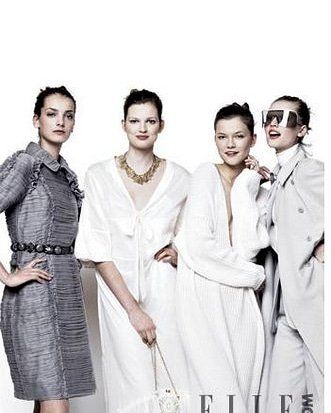 A group of four women standing next to each other on a white background