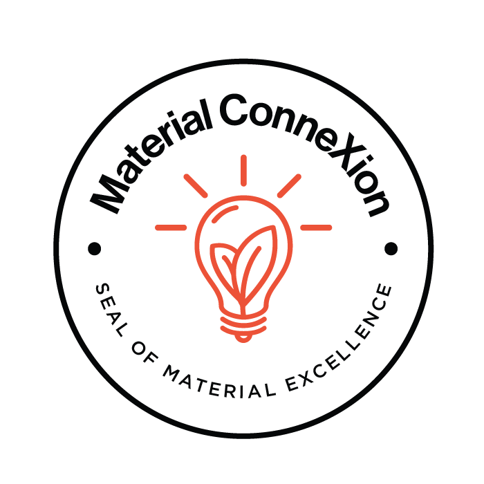 A seal of material excellence with a light bulb in the center.