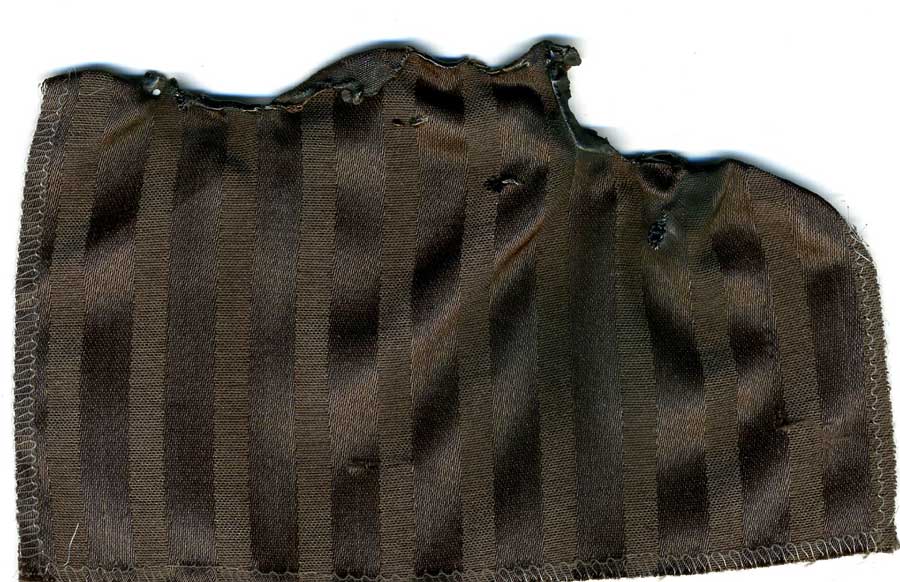 A piece of brown striped fabric with a white background