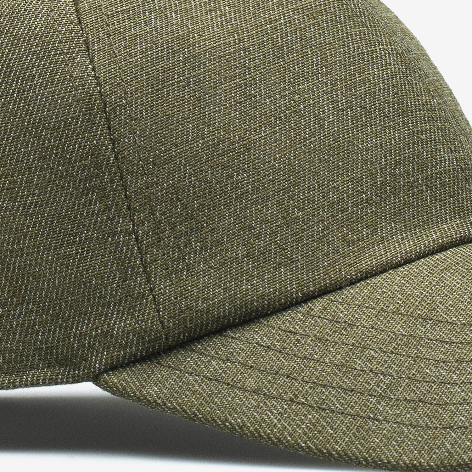 A close up of a green baseball cap on a white background.