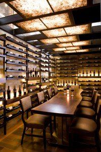 A wine cellar with a long table and chairs