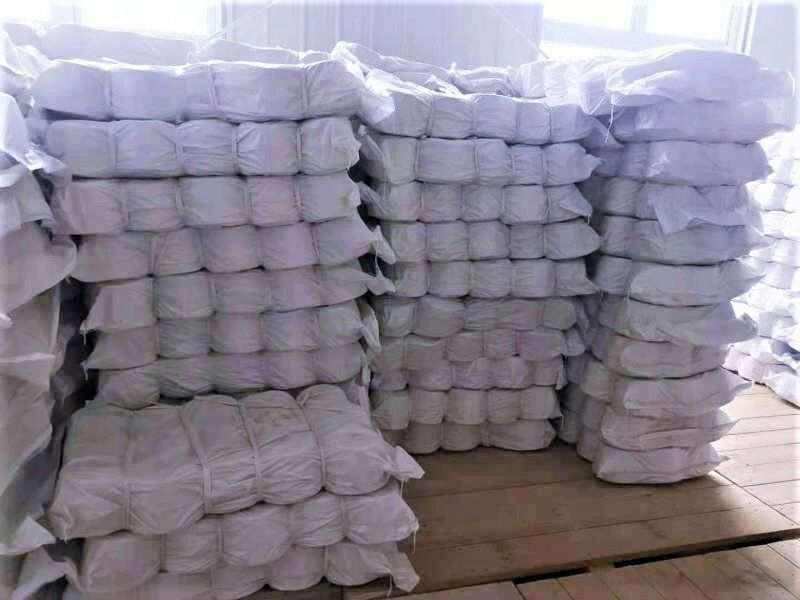 A pile of white bags stacked on top of each other on a table.