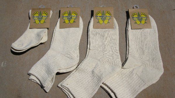 Four pairs of white socks are sitting on a table