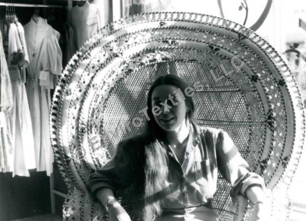 A black and white photo of a woman sitting in a chair