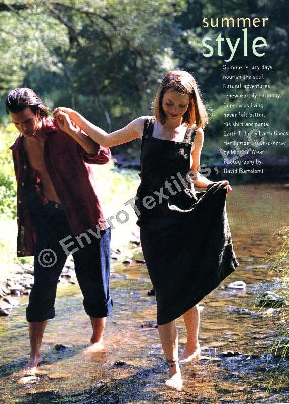 A man and a woman are walking barefoot in a river ..