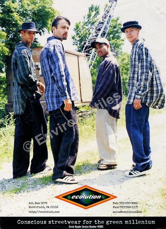 A group of men are standing next to each other on a dirt road.