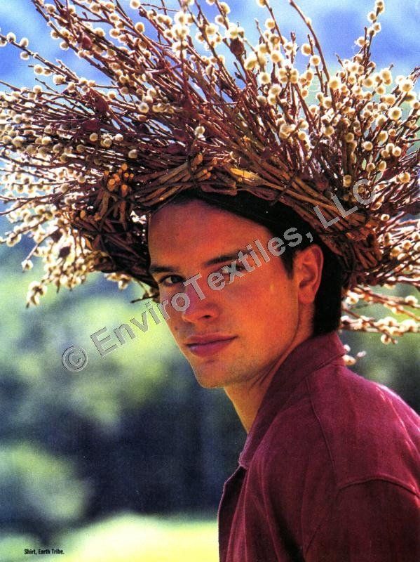 A man wearing a wreath of branches on his head