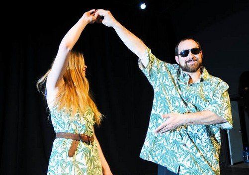 A man and a woman are dancing on a stage.