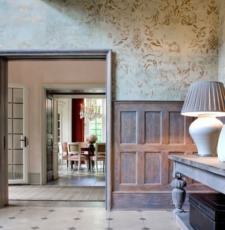 A room with wood paneling and a lamp on a table