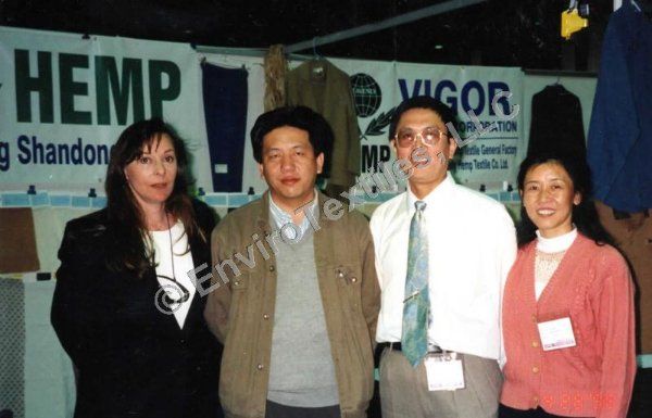 A group of people standing in front of a sign that says hemp