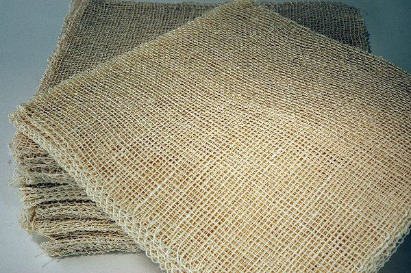 A stack of burlap napkins sitting on top of each other on a table.