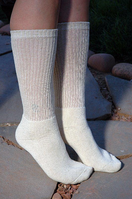 A pair of white socks on a person 's feet