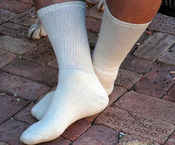 A pair of white socks on a person 's feet