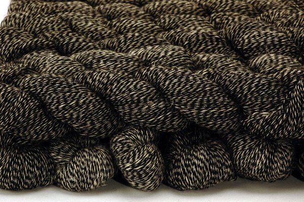 A close up of a pile of yarn on a white surface.