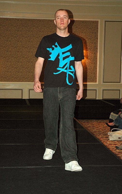 A man wearing a black shirt with chinese writing on it