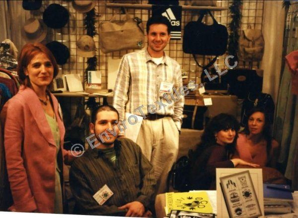 A group of people are posing for a photo in front of a wall that says adidas on it