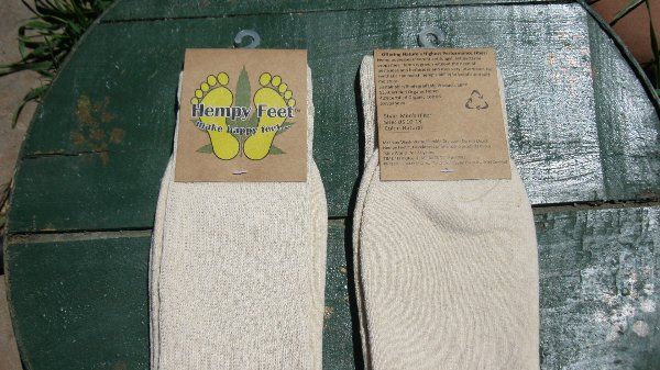 Two pairs of socks are sitting on a green table